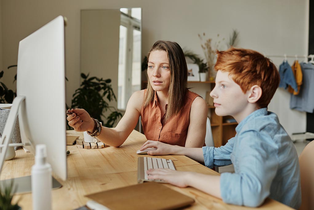 Mother helps child with homework